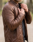 1847 copper brown lamb nappa polish leather jacket with patterned shoulders, zipped pockets and an adjustable waist cinch strap